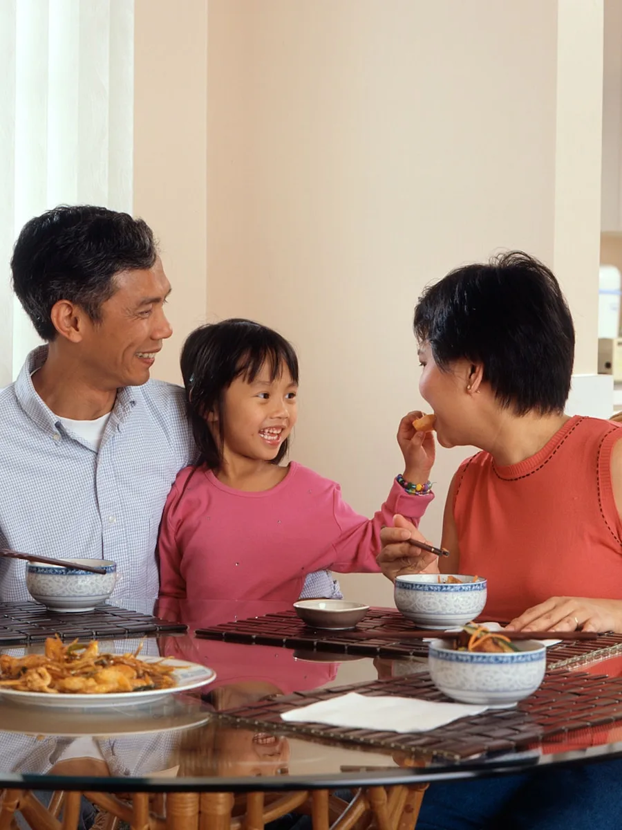 Filipino family sharing a meal together at the dining table